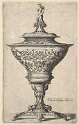 Ornate goblet on feet of masks