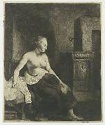 Woman sitting half dressed beside a stove